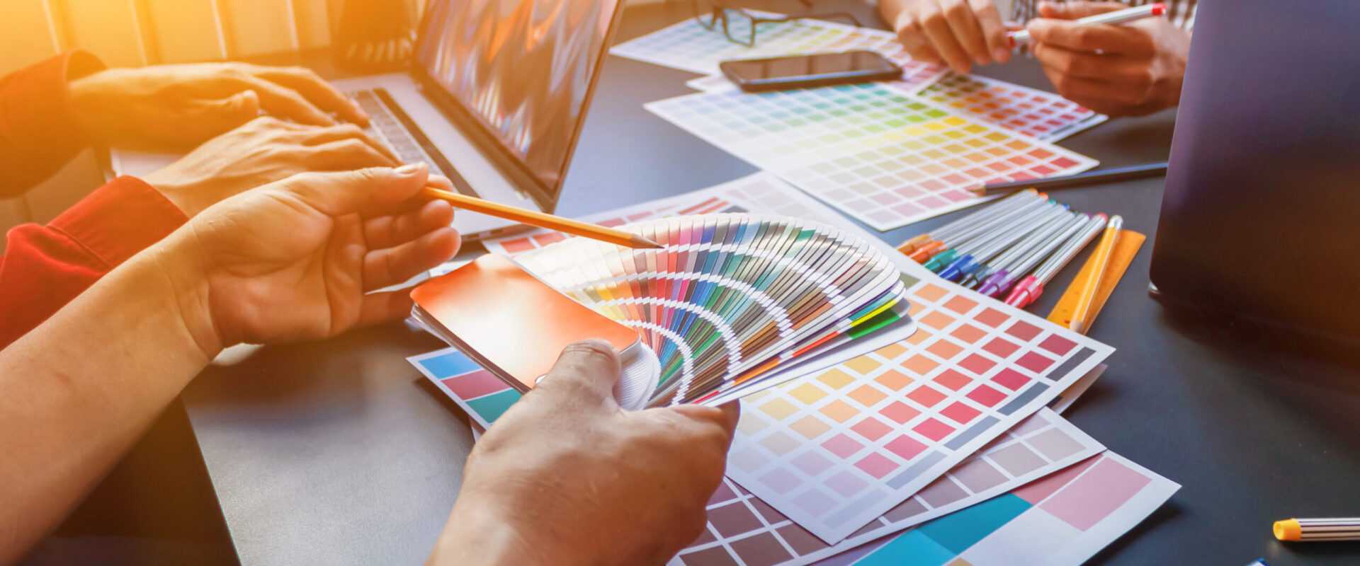 A team of web designers are working together to develop a mobile responsive website with UI / UX Front End Designer Previewing. Website development concept UI / UX front end designer